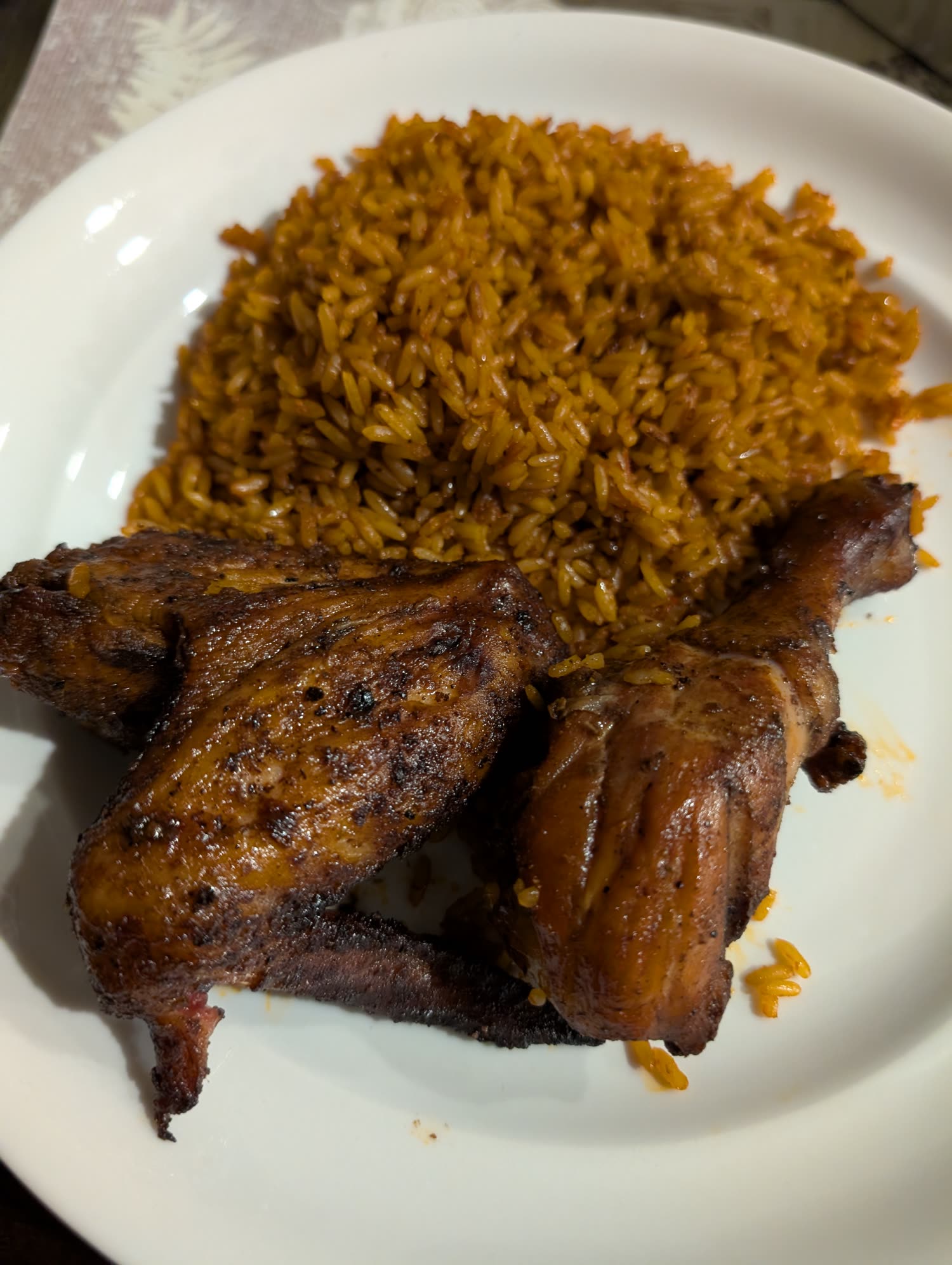 Smoked chicken over signature jollof rice